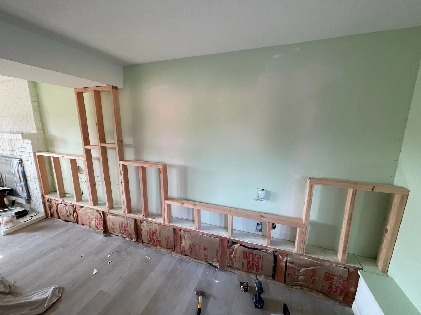 New 2x4 framing for a built-in shelving wall, with insulation along the base