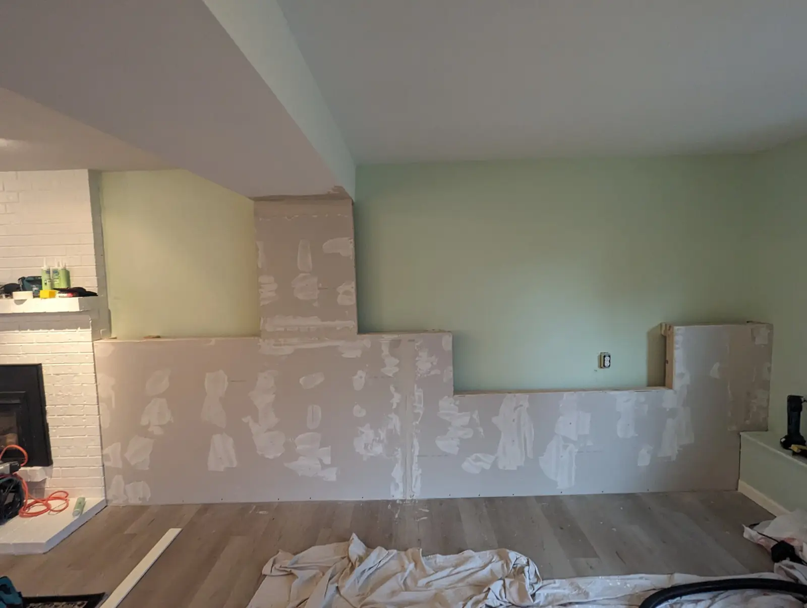 The built-in wall sheathed in drywall with mud on the screws and seams