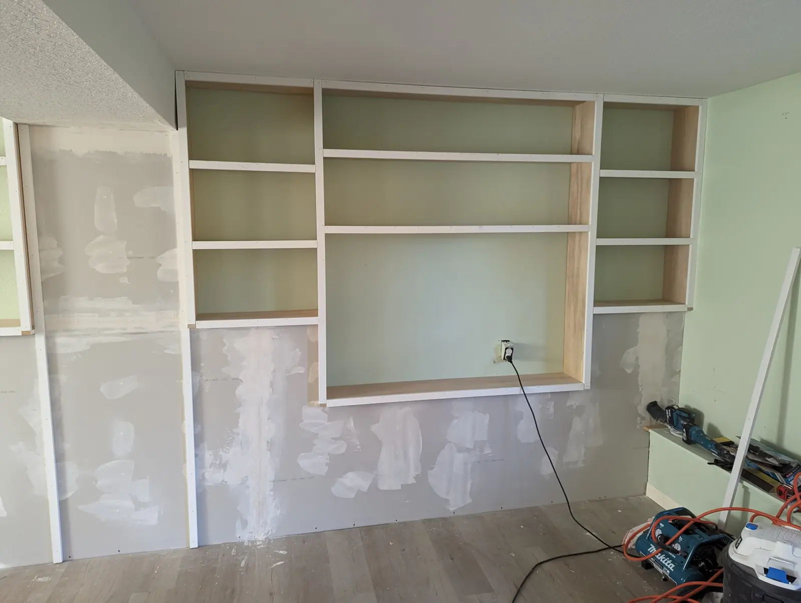 Shelving boxes and white face frames installed in the wall openings