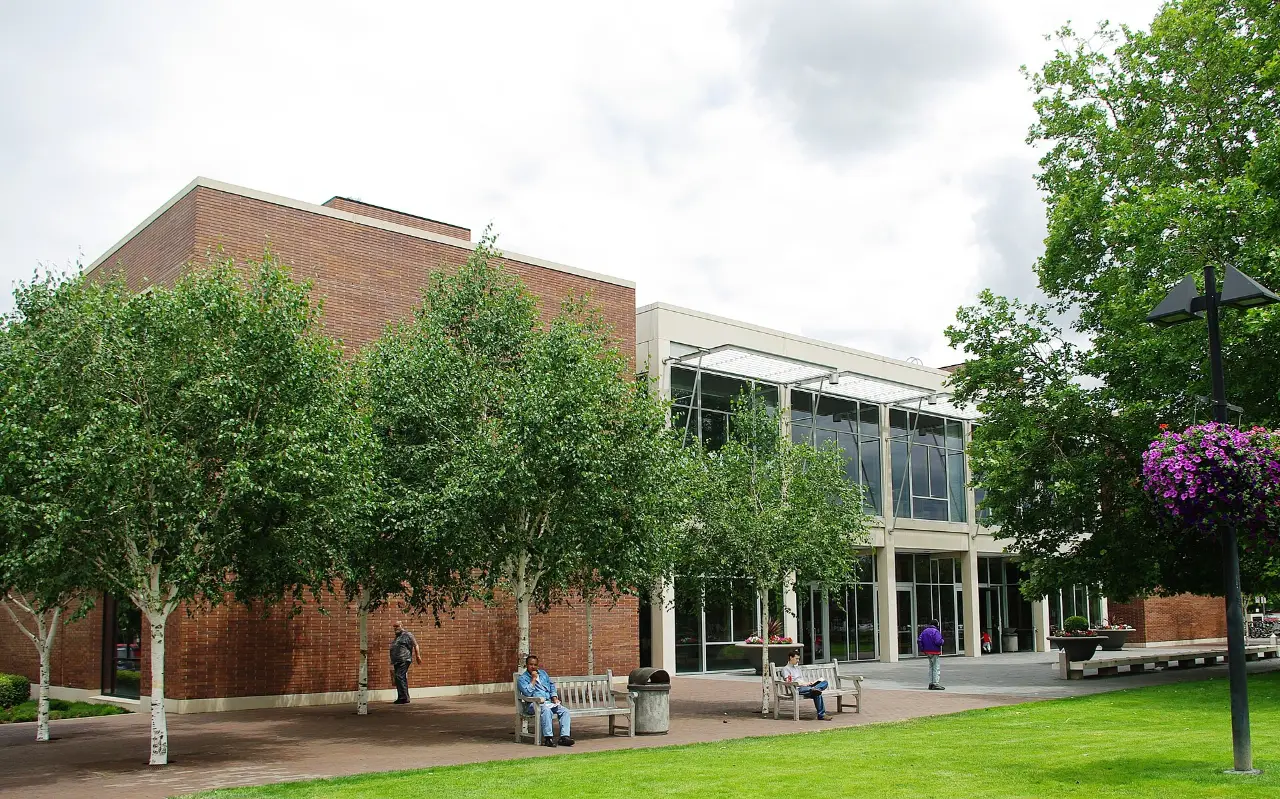 Beaverton City Library, a brick building with tall windows and trees out front