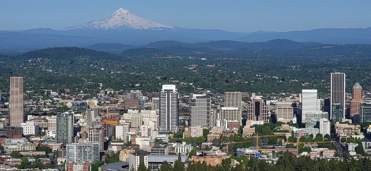 Downtown Portland skyline with Mt. Hood behind it, seen from Pittock Mansion