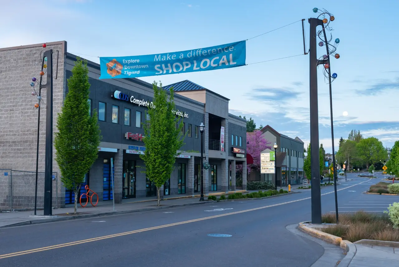 Shops along Main Street in downtown Tigard under a Shop Local banner