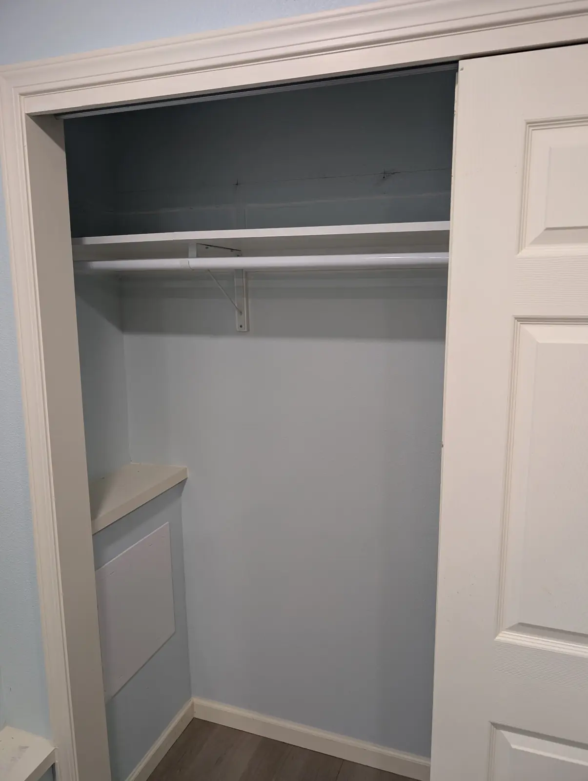 Finished closet with a shelf, hanging rod and new casing