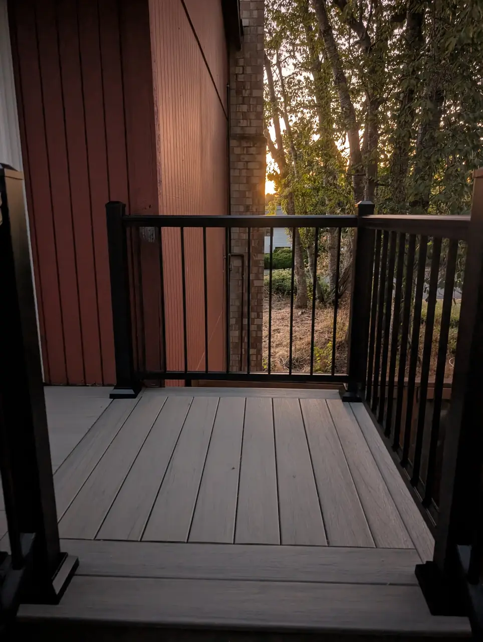Composite stair landing with black aluminum railing