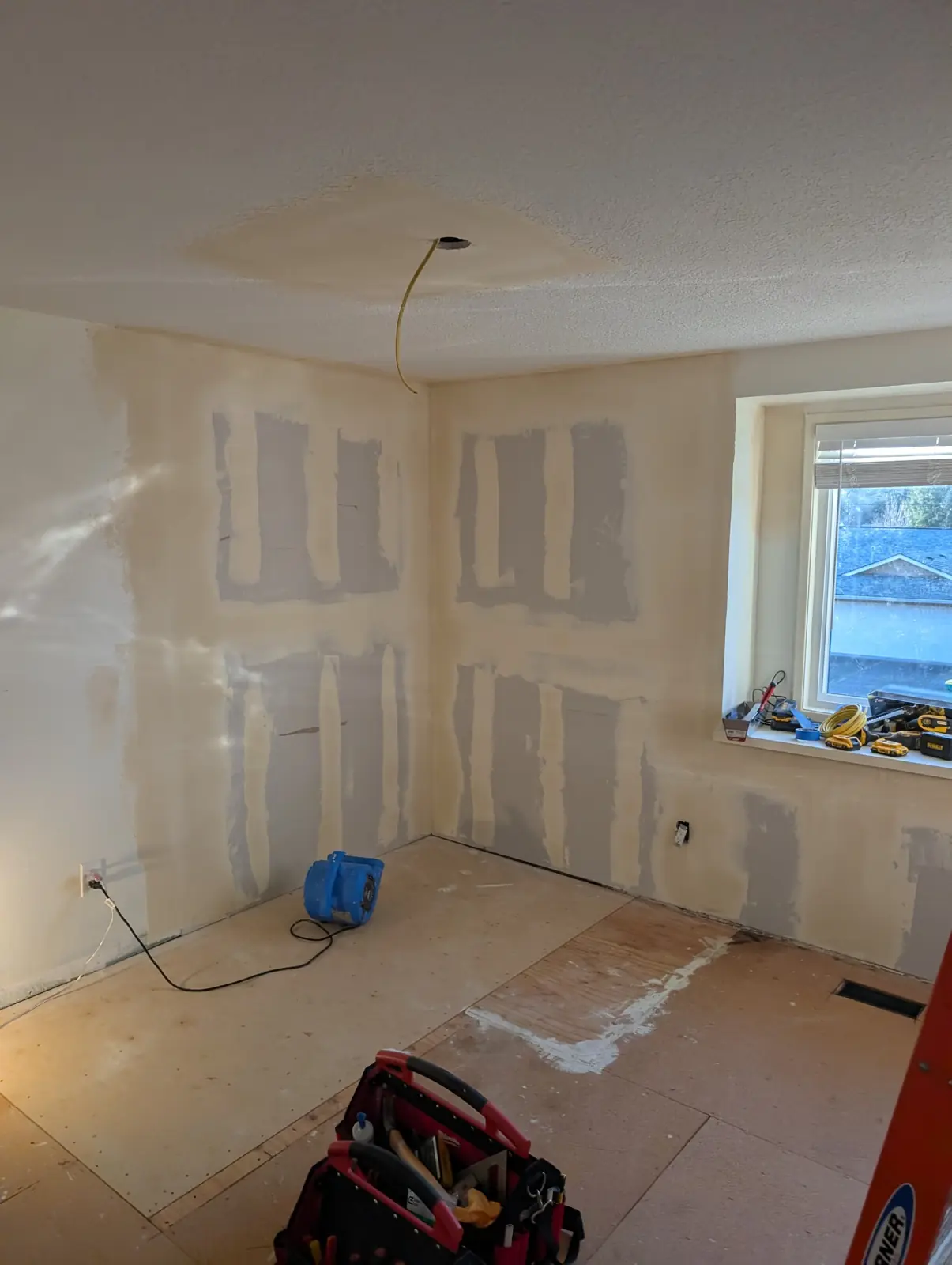 Bedroom walls with fresh drywall patches, taped and mudded