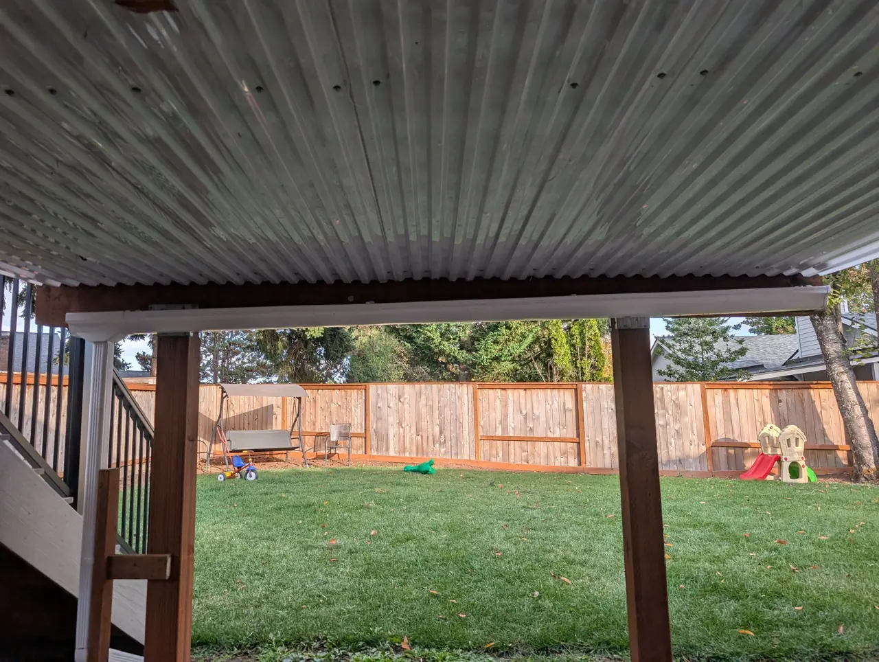 Corrugated under-deck drainage ceiling with a gutter, keeping the patio below dry
